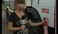 News reporter demonstrates fire extinguisher